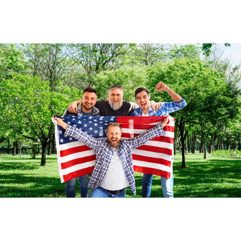 men holding a flag in a park with trees and green grass